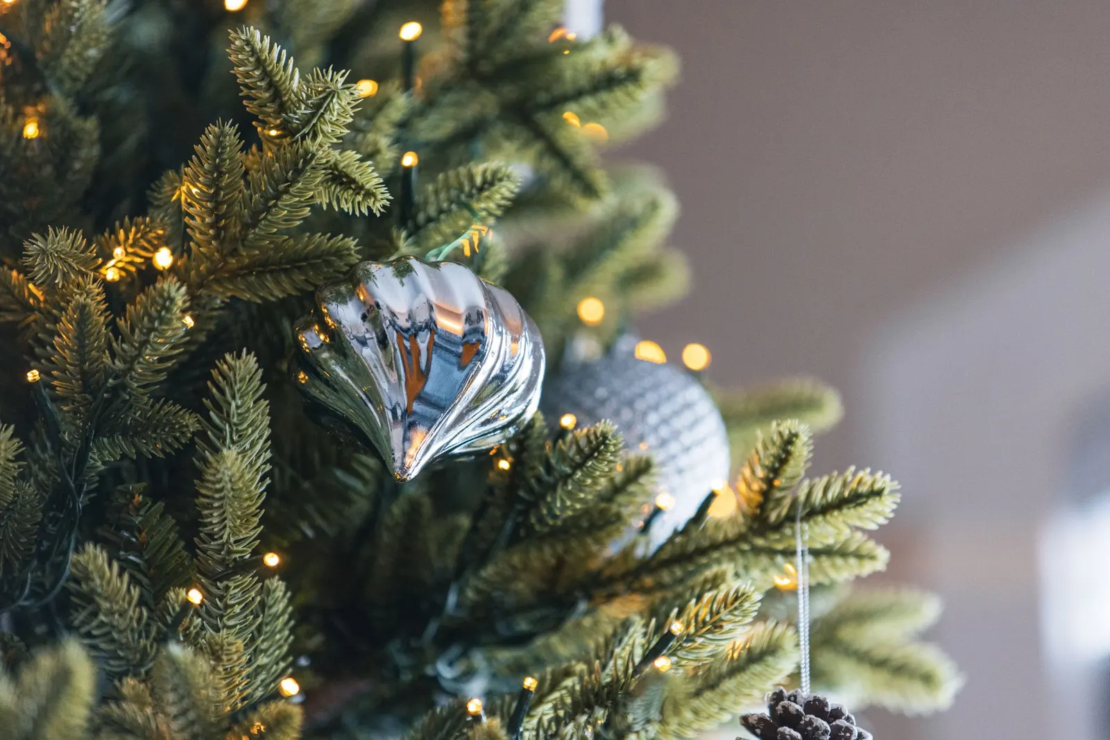 Close-up of artificial Christmas tree branches showing molded needle tips next to flat plastic needles