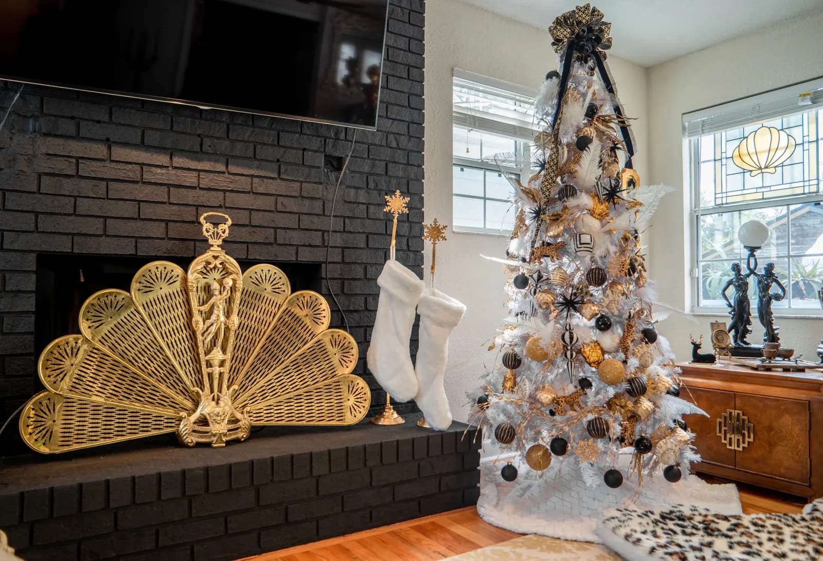 Slim pencil-shaped artificial Christmas tree with white lights in a narrow apartment corner