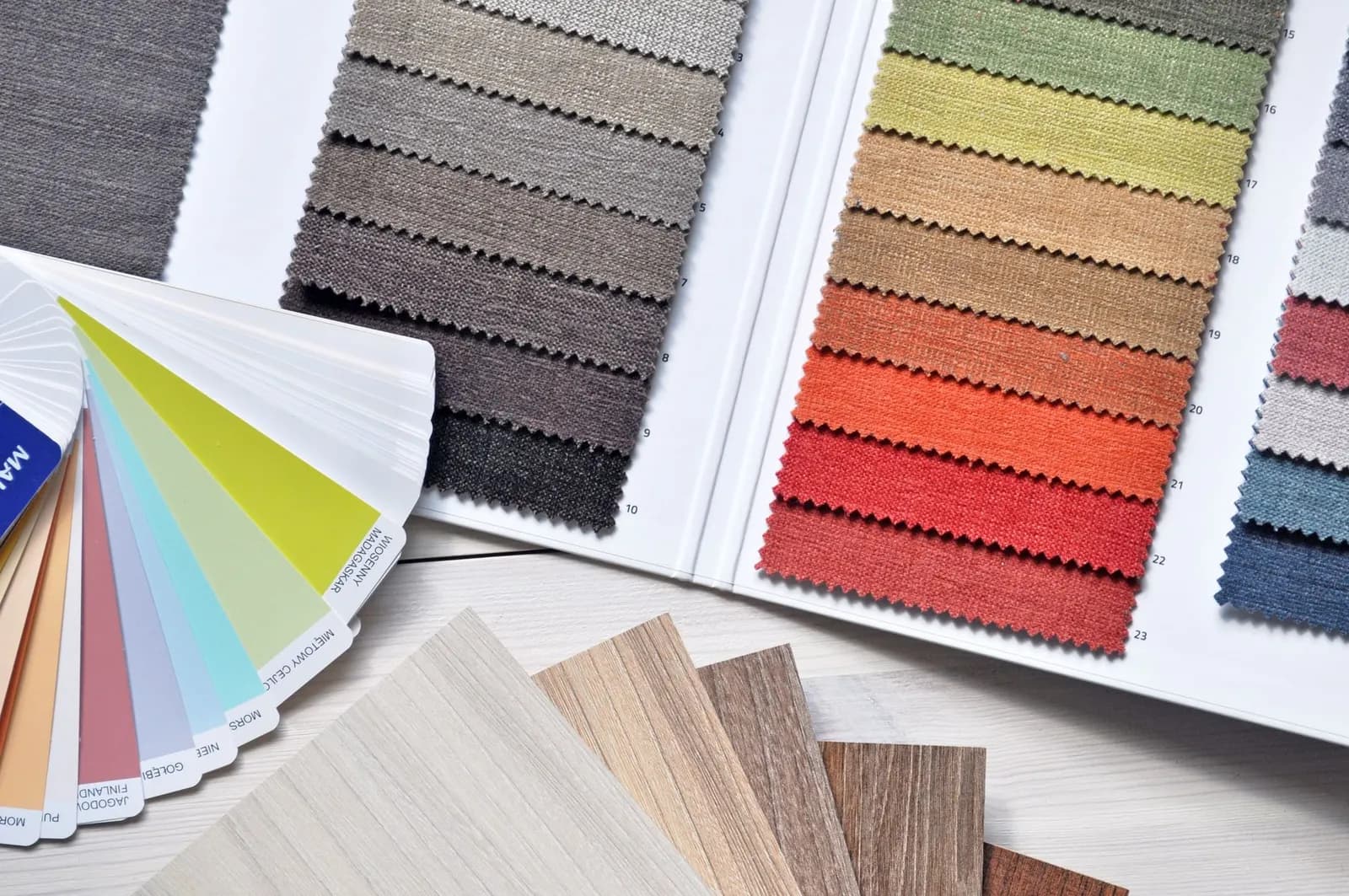 Paint swatch cards fanned out in greens, blues and warm browns