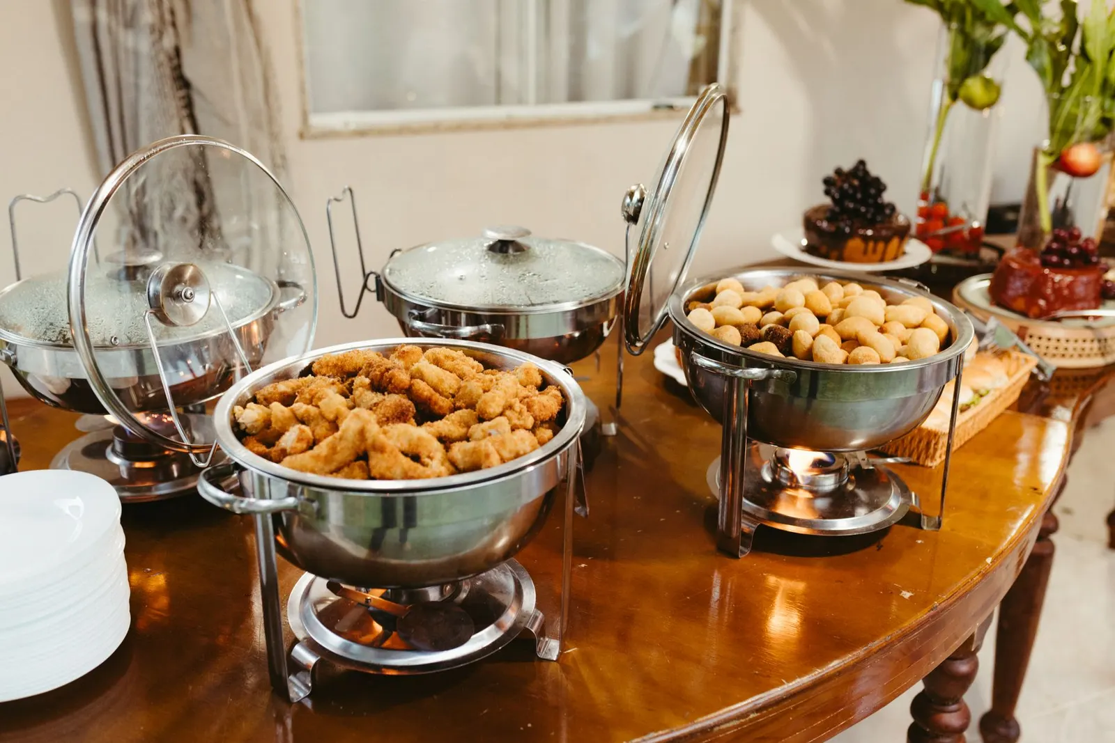 Side table buffet with a burlap runner, serving dishes, small pumpkins and kraft tag labels